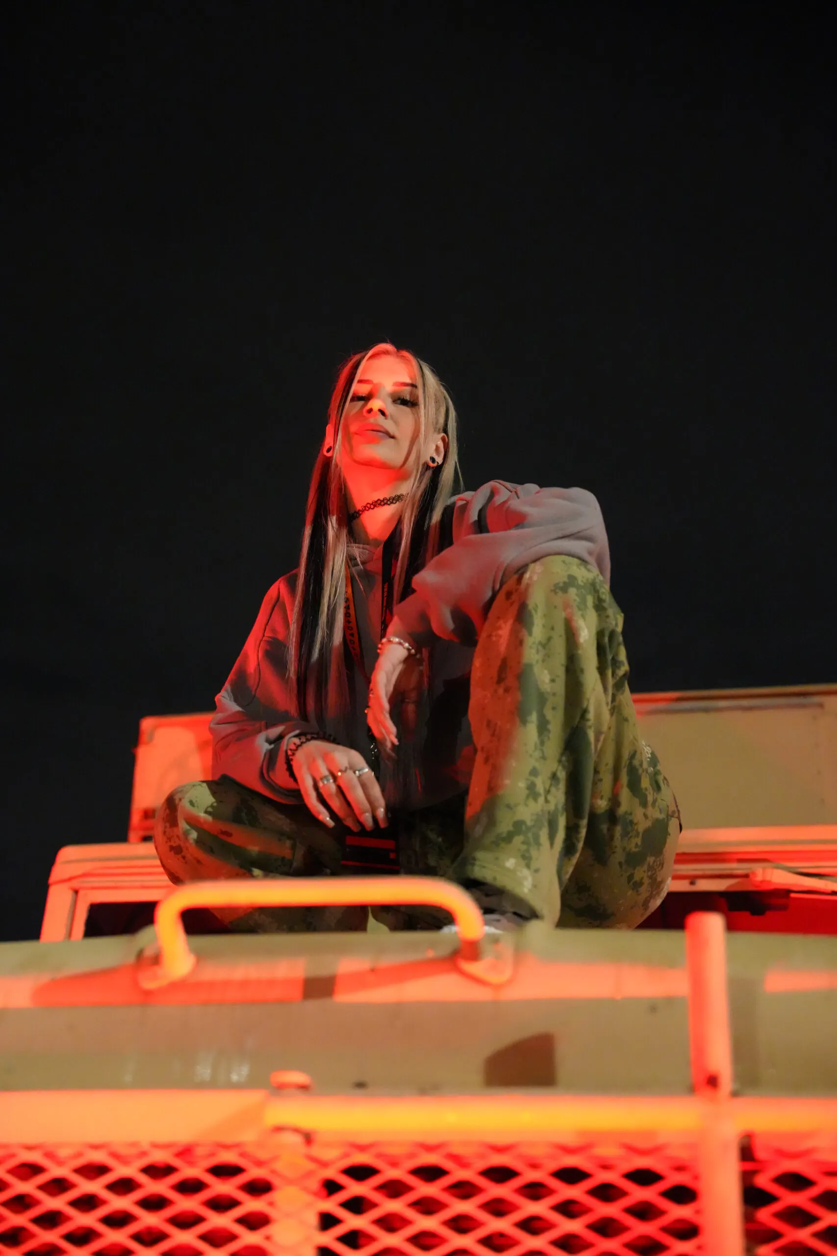 Woman sitting on a car roof in soft studio light