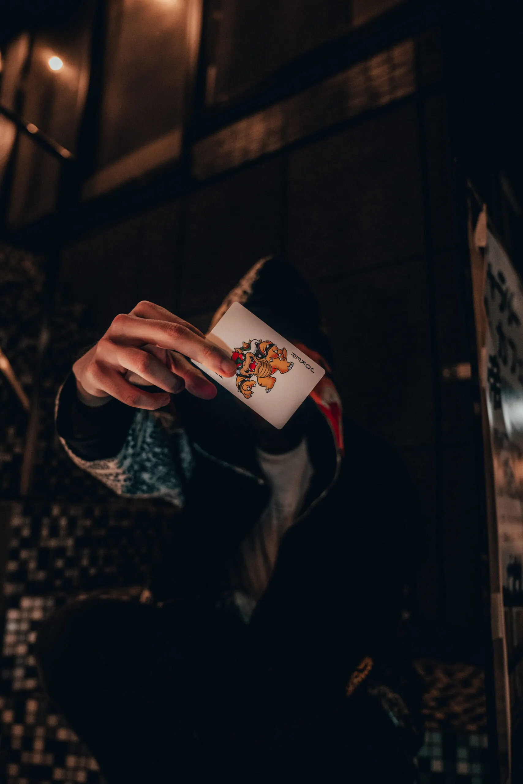 Hand holding a paper cup in a dark alley